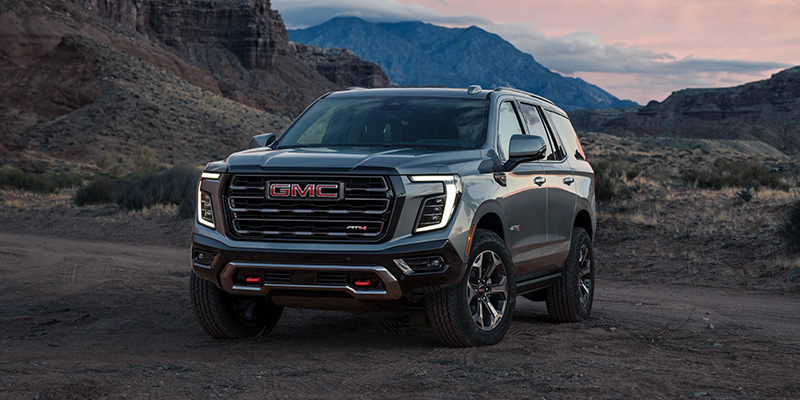 2025 GMC Yukon off-road SUV with rugged tires and raised suspension.