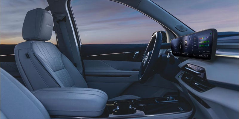 Modern luxury vehicle interior featuring leather seats, a digital display, and a sleek minimalist dashboard design.