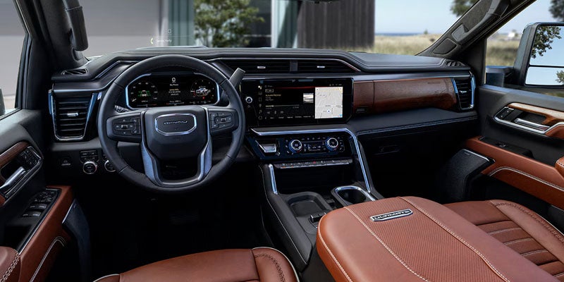 Luxury vehicle interior featuring a leather-trimmed cabin, digital dashboard, touchscreen display, and premium seating.
